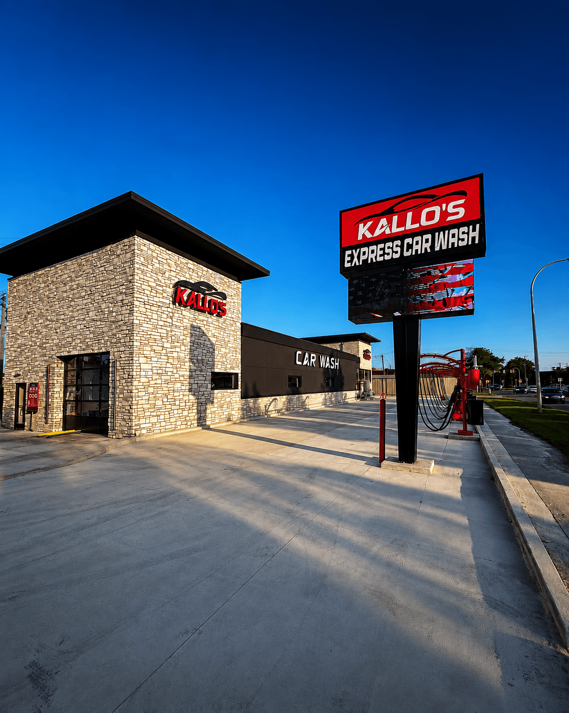 Kallo's Express Car Wash storefront and illuminated sign at sunset in Melvindale, Michigan